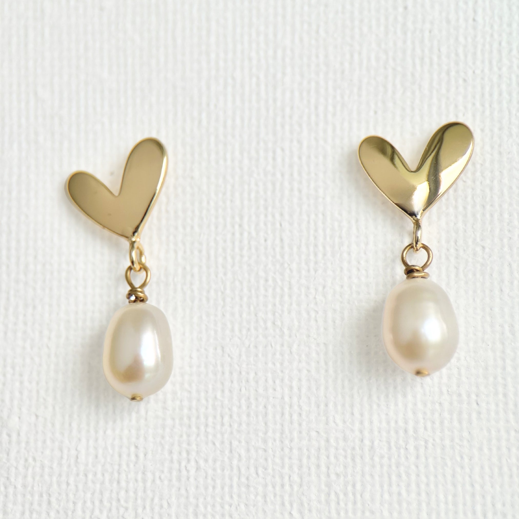 Natural Pearl Heart Stud Earrings featuring natural pearl and gold-plated brass, silver ear pins by Toronto-based Meng Jewellery