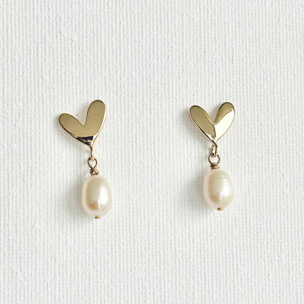 Natural Pearl Heart Stud Earrings featuring natural pearl and gold-plated brass, silver ear pins by Toronto-based Meng Jewellery