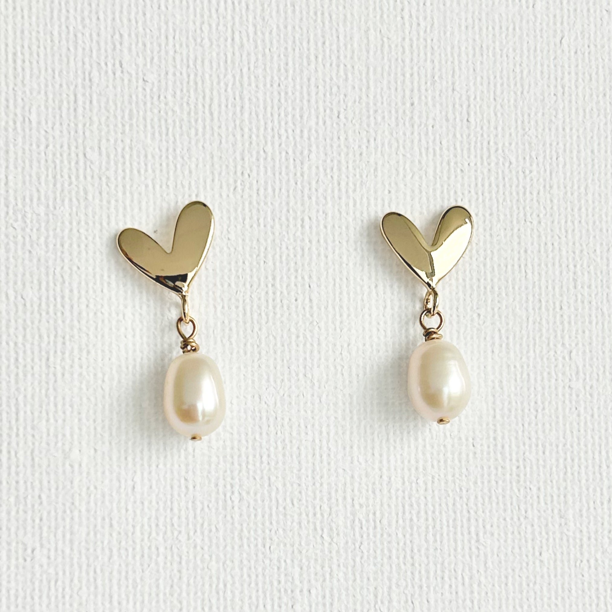 Natural Pearl Heart Stud Earrings featuring natural pearl and gold-plated brass, silver ear pins by Toronto-based Meng Jewellery