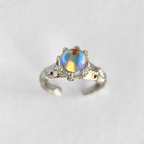 Mossborne opal ring with iridescent blue stone and adjustable silver band